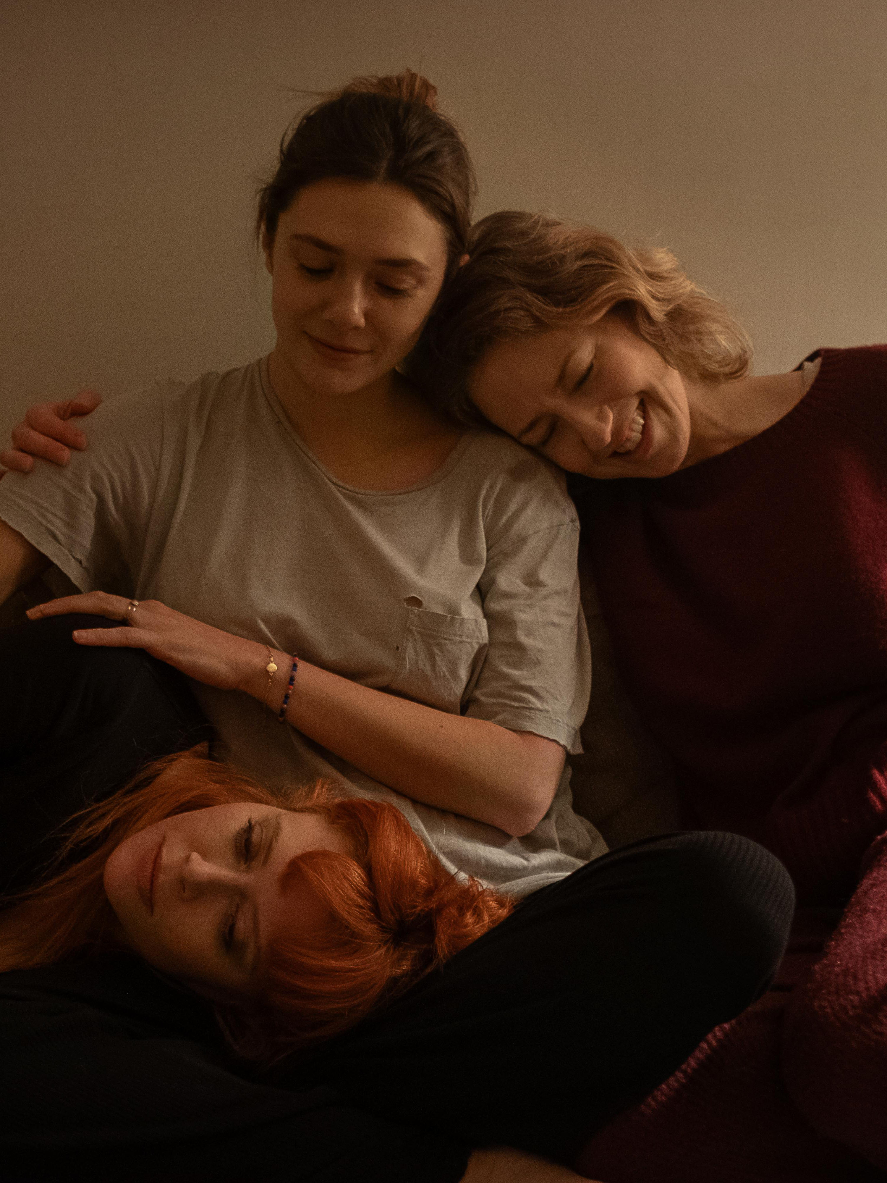 three women together on a sofa